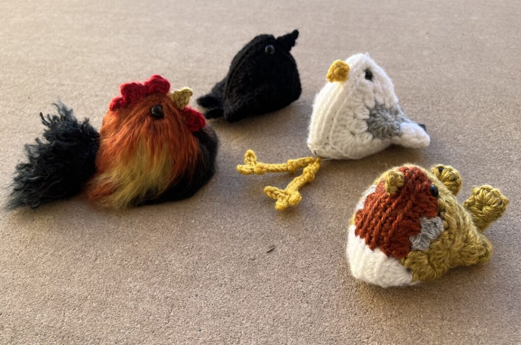 Birds made from 2 granny squares each: black breasted red phoenix, crow / raven, seagull, european robin.